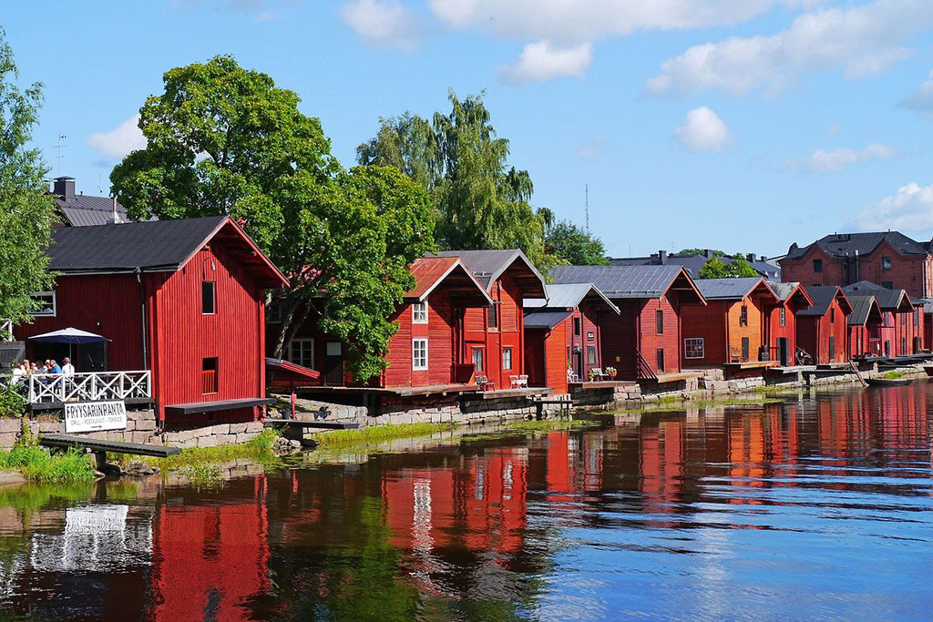 Red wooden houses by a lake in the town of Porvoo in Finland