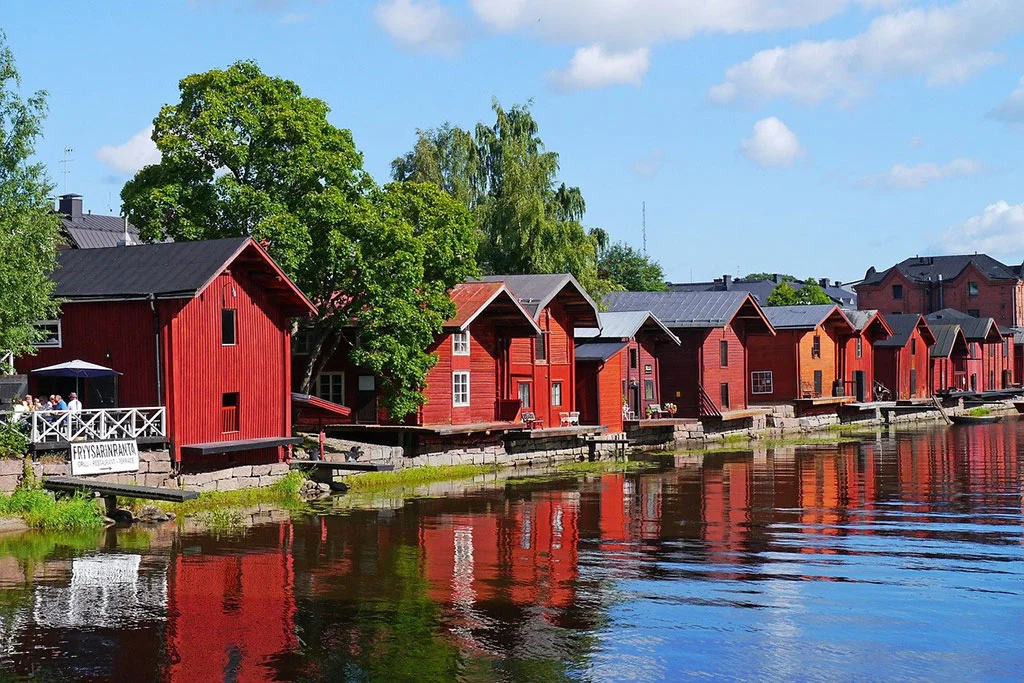 Red wooden houses by a lake in the town of Porvoo in Finland